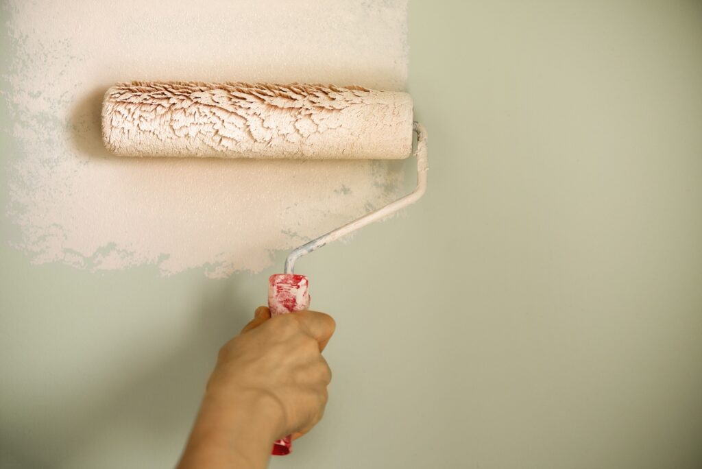 hand-painting-wall-with-paint-roller-pastel-color-appartment-renovation-repair-building-and-home-1024x684-1